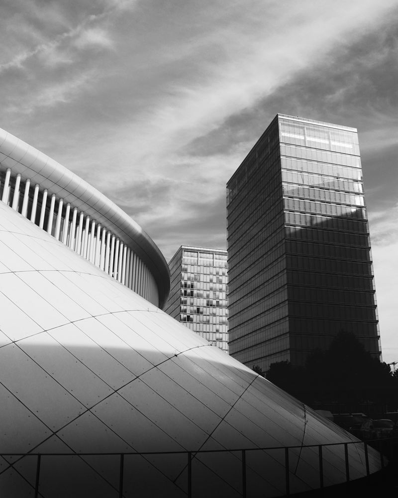 The curved white facade of the Philharmonie Luxembourg on the Kirchberg plateau