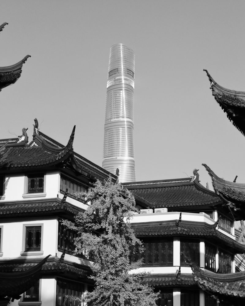 Shanghai Tower rising behind the upturned eaves of Yuyuan Garden, Shanghai