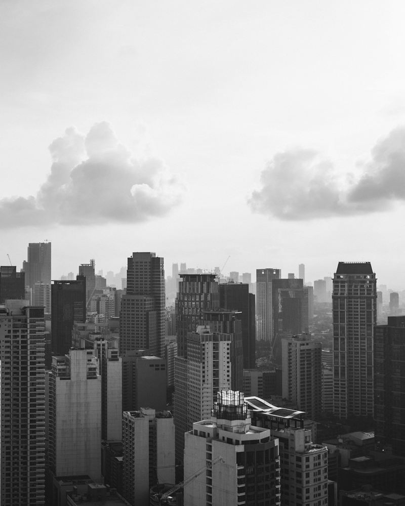 Hazy Makati skyline of office and residential towers under soft cloud
