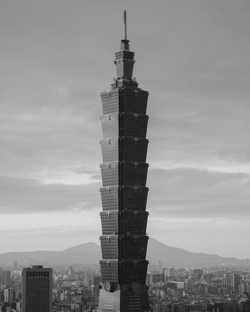 Taipei 101 rising above the city with mountains behind, Taipei