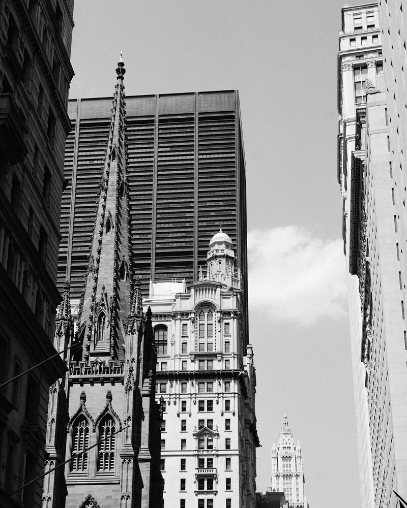 The Gothic spire of Trinity Church rising between Financial District towers in Lower Manhattan