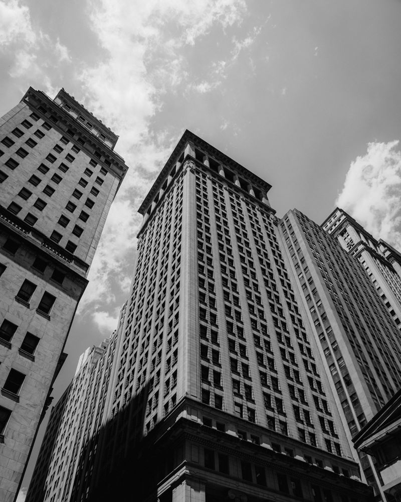 Stone towers of the Lower Manhattan financial district, seen from street level
