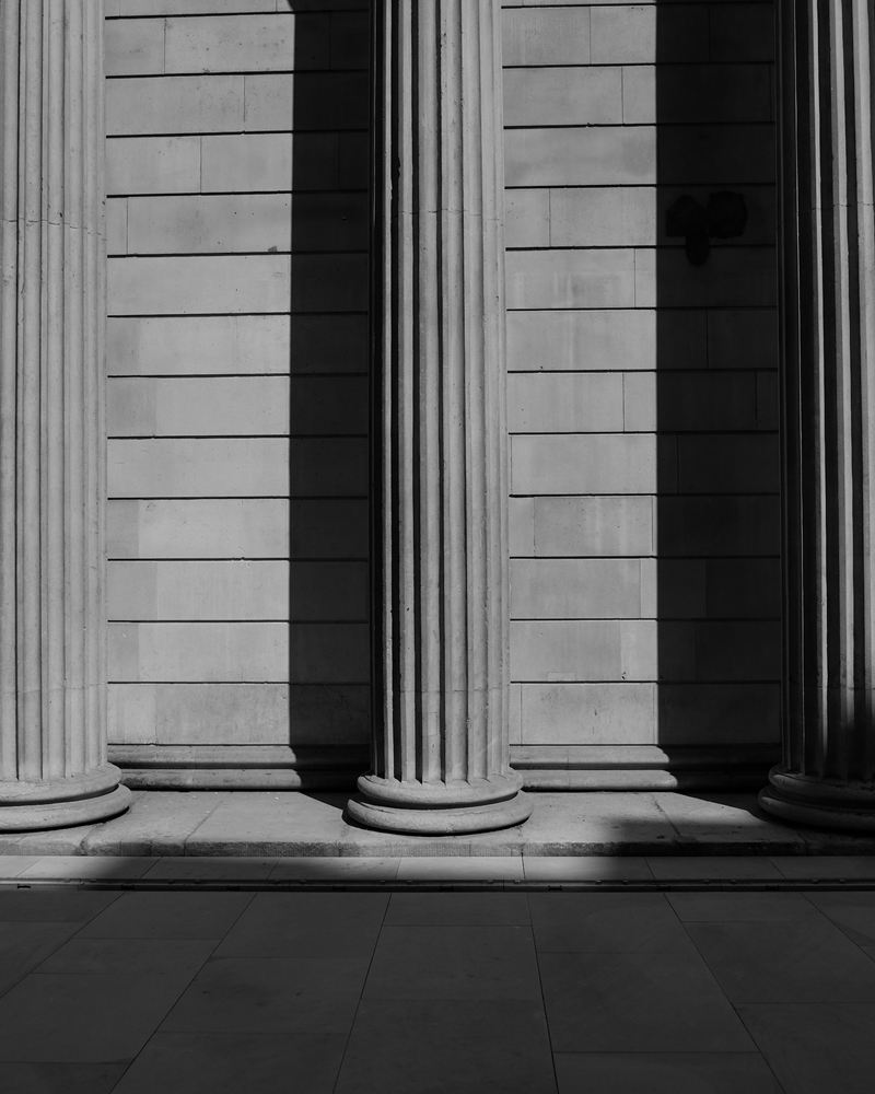 Fluted stone columns in raking light